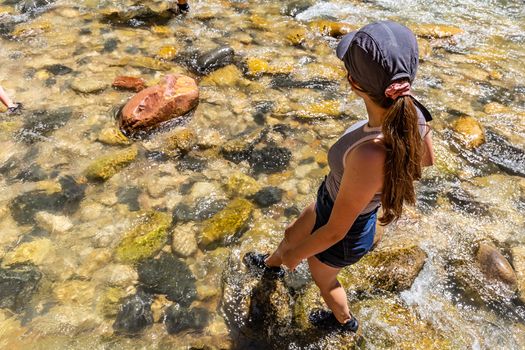 Teenage girl wading in the river, feet wet in Zion National Park, Utah, USA