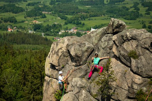 Woman climbing near the top with amazing areal view on the surroundings