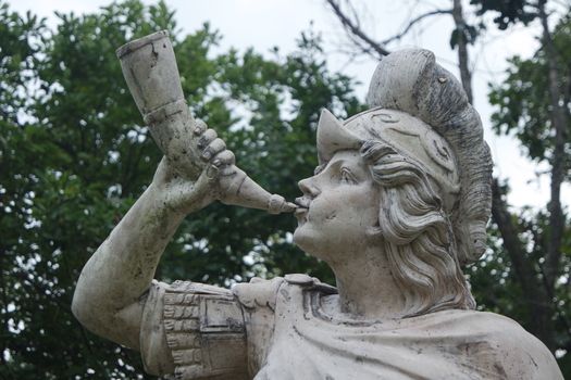 CHUNCHEON, SOUTH KOREA- October-03, 2020: sculpture of classical water god blowing conch shell - ancient natural trumpet. Stone sculpture of a Triton, blowing on his conch shell trumpet.