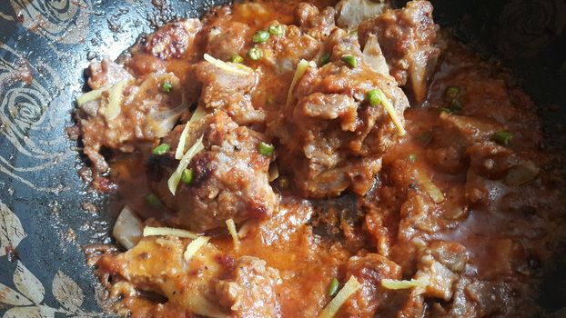 Meat, mutton or chicken curry dish in a bowl garnished with chilli and spices. Indian Pakistani tradition cuisine