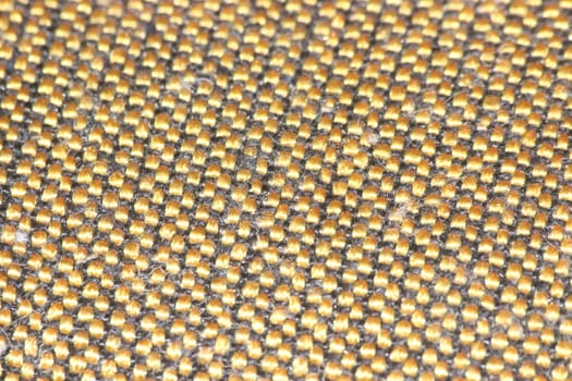 macro photo as background close up of golden color cloth fibers knitted and woven