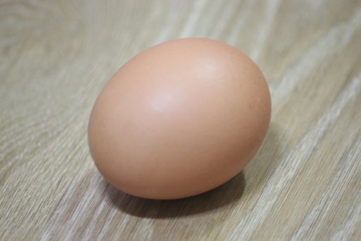 Closeup selective view of fresh farm chicken eggs isolated on a wooden background