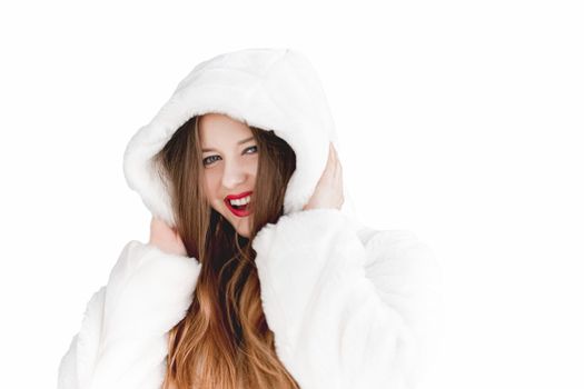 Young woman in fluffy fur coat with hood wrap, warm winter clothing for fashion and Christmas holidays design