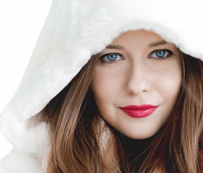 Young woman in fluffy fur coat with hood wrap, warm winter clothing for fashion and Christmas holidays design