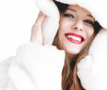Young woman in fluffy fur coat with hood wrap, warm winter clothing for fashion and Christmas holidays design