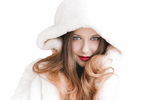 Young woman in fluffy fur coat with hood wrap, warm winter clothing for fashion and Christmas holidays design