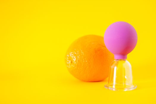 Bright oranges and a jar for anti-cellulite massage. Healthy lifestyle concept. Cellulite, diet, orange peel.