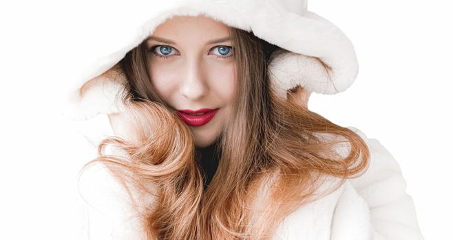 Young woman in fluffy fur coat with hood wrap, warm winter clothing for fashion and Christmas holidays design