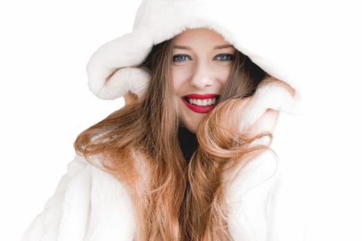 Young woman in fluffy fur coat with hood wrap, warm winter clothing for fashion and Christmas holidays design