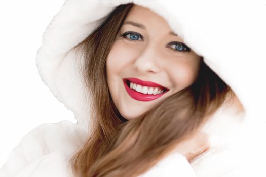 Young woman in fluffy fur coat with hood wrap, warm winter clothing for fashion and Christmas holidays design