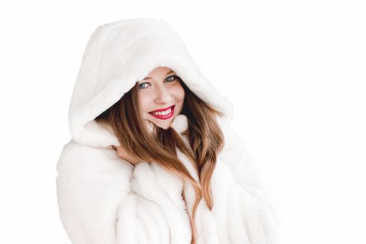 Young woman in fluffy fur coat with hood wrap, warm winter clothing for fashion and Christmas holidays design