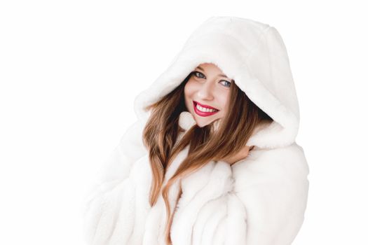 Young woman in fluffy fur coat with hood wrap, warm winter clothing for fashion and Christmas holidays design