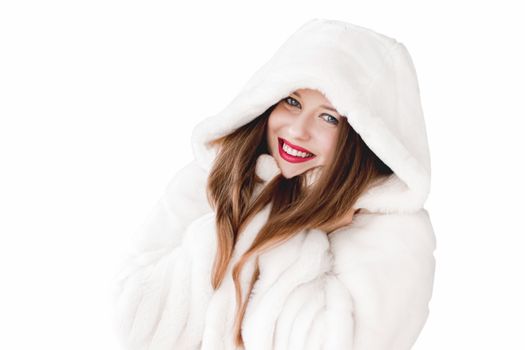 Young woman in fluffy fur coat with hood wrap, warm winter clothing for fashion and Christmas holidays design