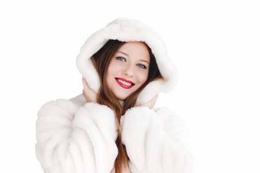 Young woman in fluffy fur coat with hood wrap, warm winter clothing for fashion and Christmas holidays design