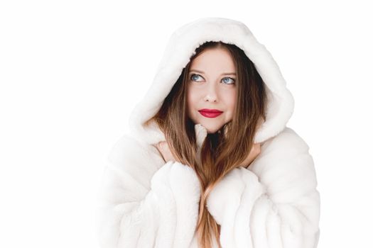 Young woman in fluffy fur coat with hood wrap, warm winter clothing for fashion and Christmas holidays design