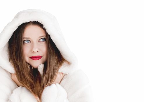 Young woman in fluffy fur coat with hood wrap, warm winter clothing for fashion and Christmas holidays design