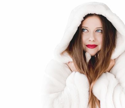 Young woman in fluffy fur coat with hood wrap, warm winter clothing for fashion and Christmas holidays design