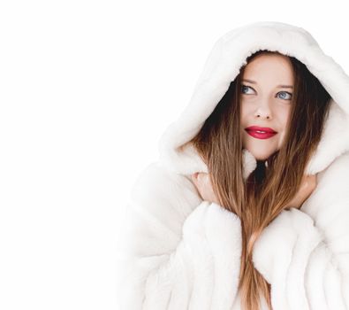 Young woman in fluffy fur coat with hood wrap, warm winter clothing for fashion and Christmas holidays design