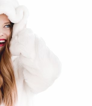 Young woman in fluffy fur coat with hood wrap, warm winter clothing for fashion and Christmas holidays design