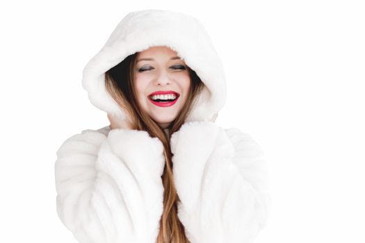 Young woman in fluffy fur coat with hood wrap, warm winter clothing for fashion and Christmas holidays design