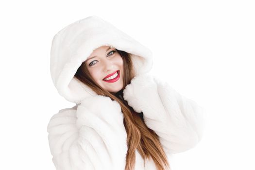 Young woman in fluffy fur coat with hood wrap, warm winter clothing for fashion and Christmas holidays design