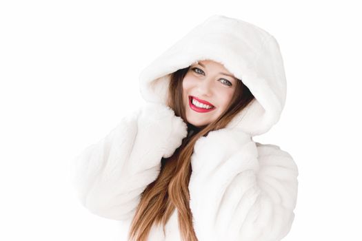 Young woman in fluffy fur coat with hood wrap, warm winter clothing for fashion and Christmas holidays design