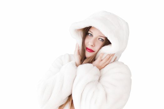 Young woman in fluffy fur coat with hood wrap, warm winter clothing for fashion and Christmas holidays design