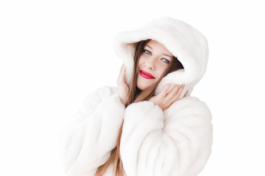 Young woman in fluffy fur coat with hood wrap, warm winter clothing for fashion and Christmas holidays design