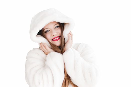 Young woman in fluffy fur coat with hood wrap, warm winter clothing for fashion and Christmas holidays design