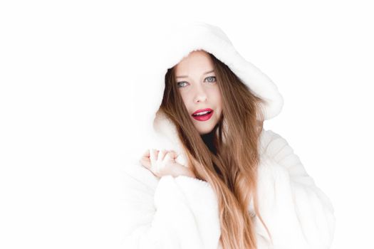 Young woman in fluffy fur coat with hood wrap, warm winter clothing for fashion and Christmas holidays design