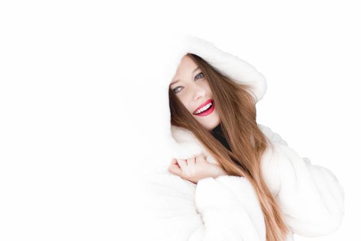 Young woman in fluffy fur coat with hood wrap, warm winter clothing for fashion and Christmas holidays design