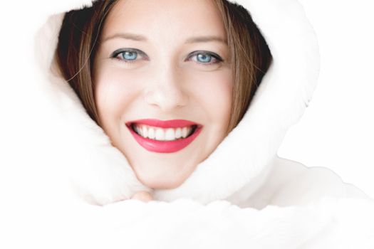 Young woman in fluffy fur coat with hood wrap, warm winter clothing for fashion and Christmas holidays design