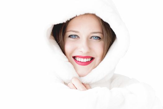 Young woman in fluffy fur coat with hood wrap, warm winter clothing for fashion and Christmas holidays design