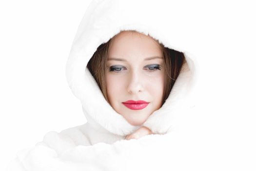 Young woman in fluffy fur coat with hood wrap, warm winter clothing for fashion and Christmas holidays design