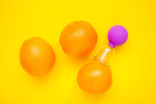 Bright oranges and a jar for anti-cellulite massage. Healthy lifestyle concept. Cellulite, diet, orange peel.