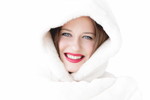 Young woman in fluffy fur coat with hood wrap, warm winter clothing for fashion and Christmas holidays design