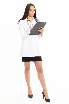 A young woman wearing a hospital apron saves various information during an inspection.