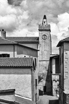 Historic clock tower in the city of Magliano in Toscana, Italy, monochrome
