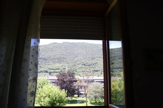 view of green mountains through the windows