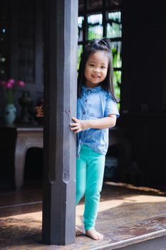 little girl standing in the house