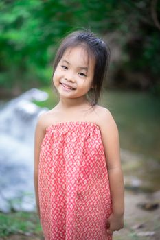 Portrait of little asian girl prepare to playing in nature water on holiday
