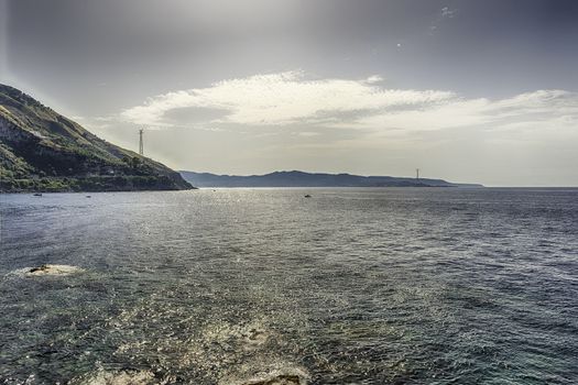 Scenic panoramic view of the Strait of Messina, between the eastern tip of Sicily and the western tip of Calabria in the south of Italy, as seen from the town of Scilla, Italy