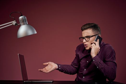 Business man in office and talking on the phone manager red background model cropped view of laptop tablet. High quality photo