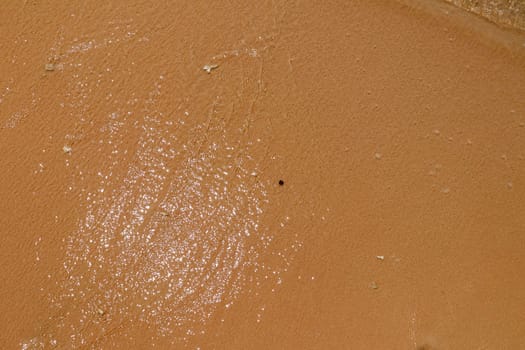 sea water and sand on the shore. View from above.