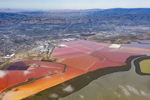 Aerial photo of vivid red salt ponds at Don Edwards San Francisco Bay National Wildlife Refuge. California, USA