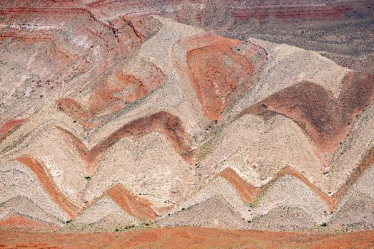 Interesting background of red banded strata viewed from Highway 163. The zigzag pattern is result of erosion of the tilted strata. Mexican Hat, Utah - USA