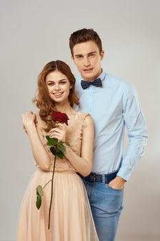 Young couple hugs romance dating lifestyle relationship light background red rose. High quality photo