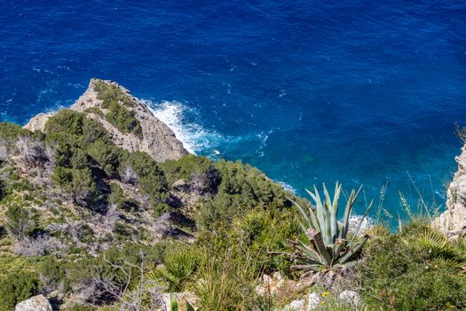 Scenic view from viewpoint Mirador Ricardo Roco on a bay at the north coast of Mallorca with rocky coastline and clear turquoise water
 