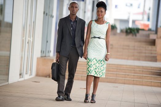 business partners walking side by side and chatting on the stairs.