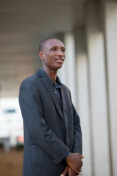 young businessman, handsome standing in costume and confident in a driveway.